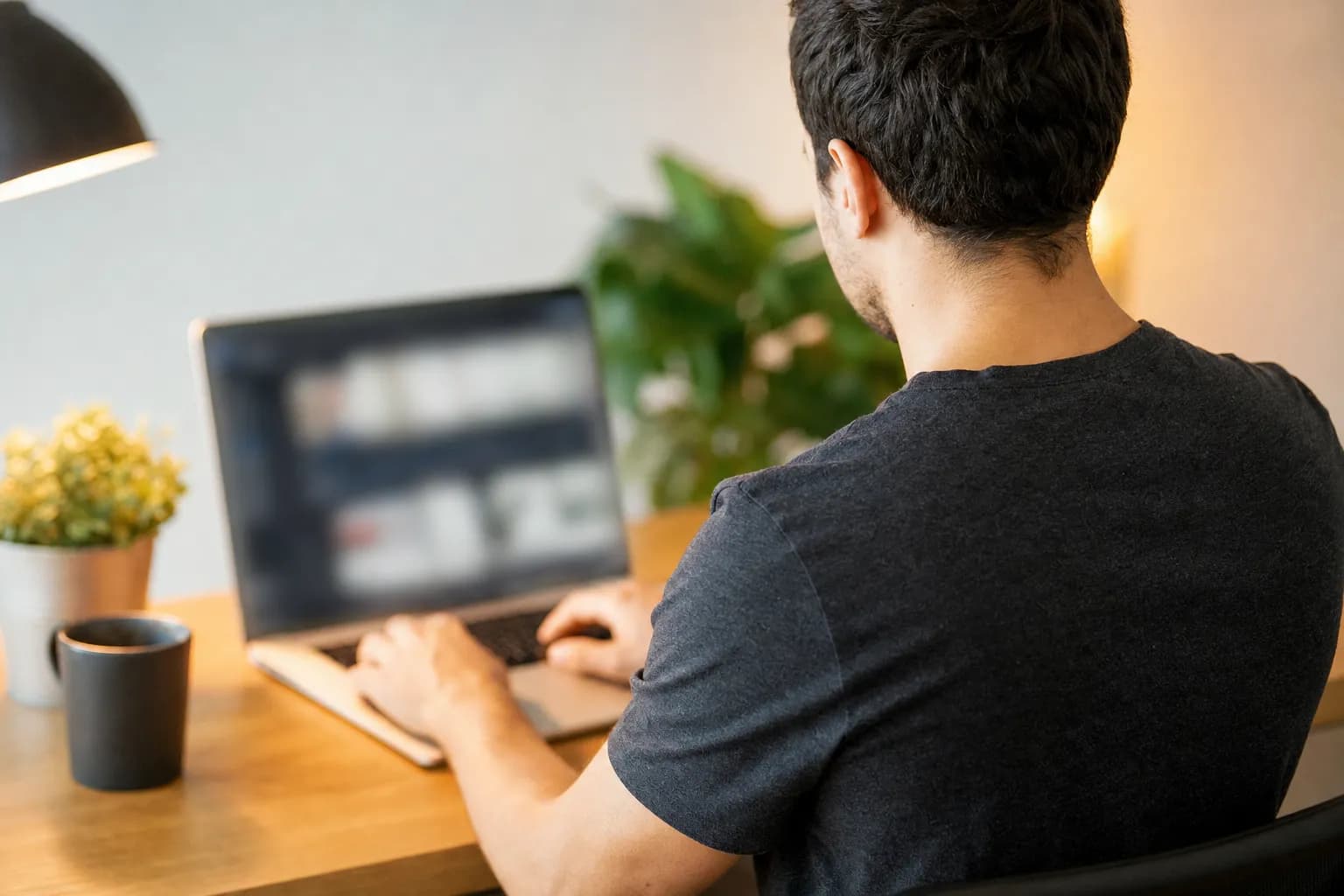 A home service business owner writing a guest article on a laptop to earn editorial backlinks